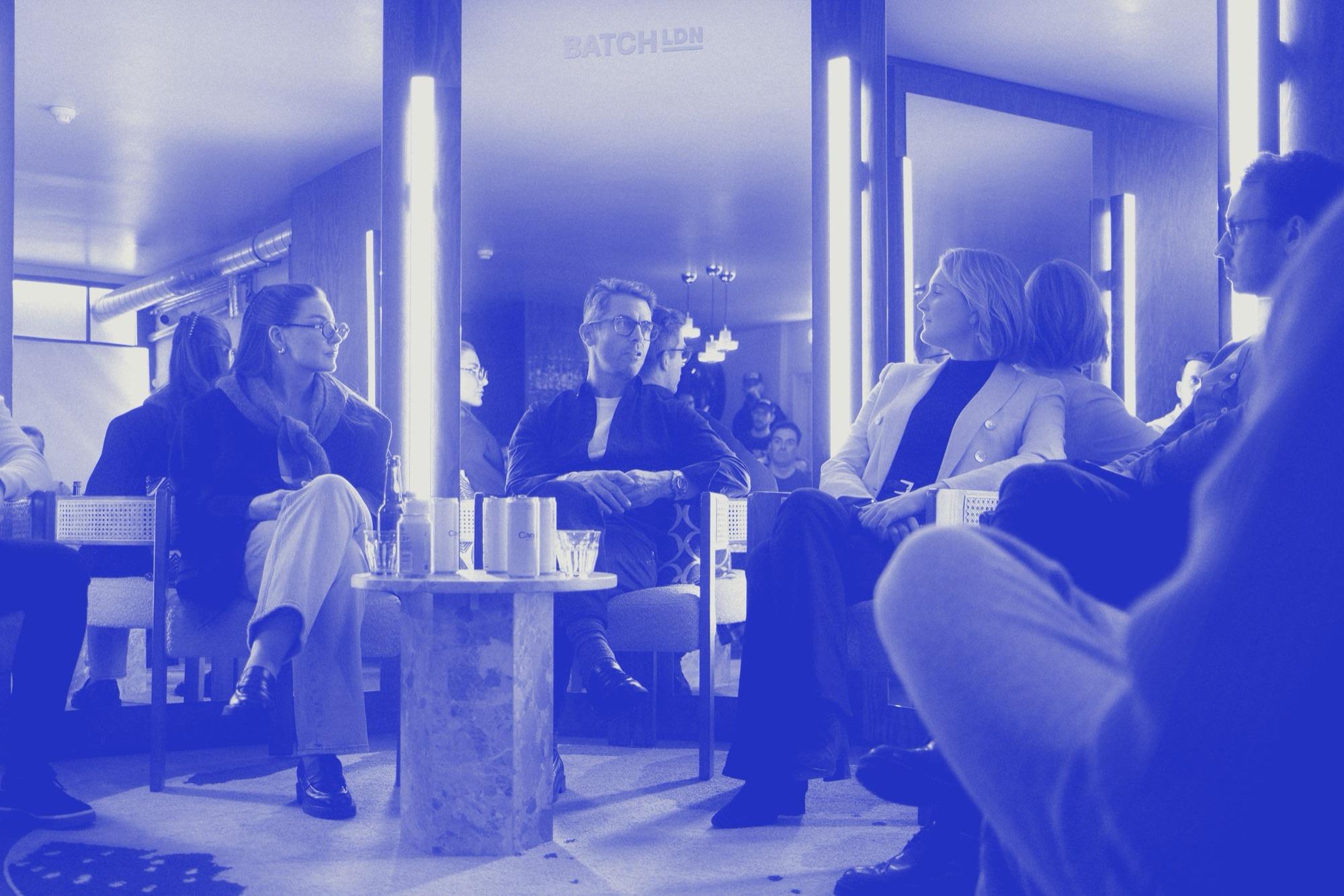 Founders in conversation at a Venice Founders evening, in ultramarine duotone